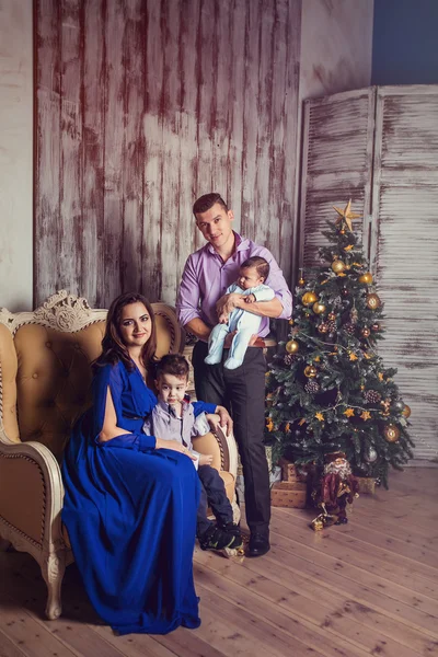 A young family of four in new year interior
