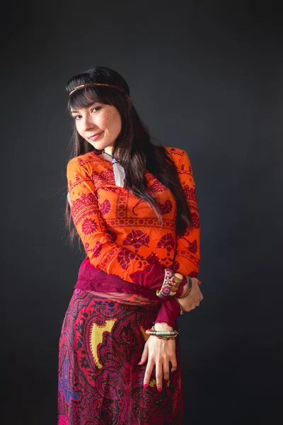 American Indian woman in ethnic ritual clothes in the Studio