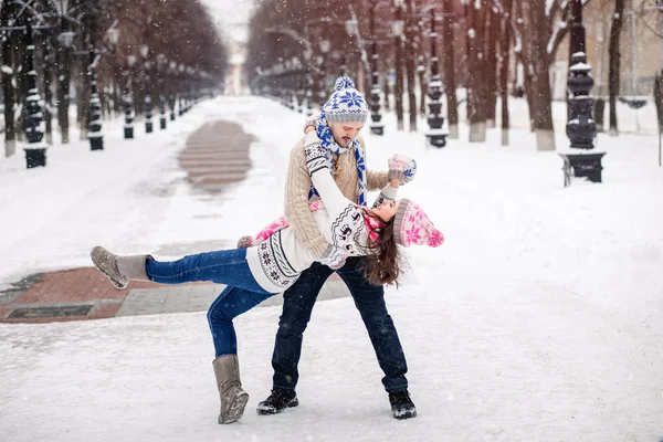 Young couple in love dancing in winter Park.