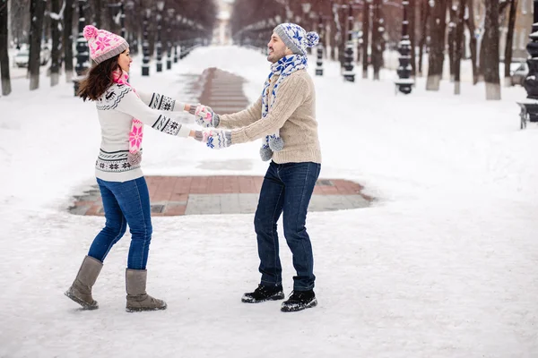 Young couple in love dancing in winter Park
