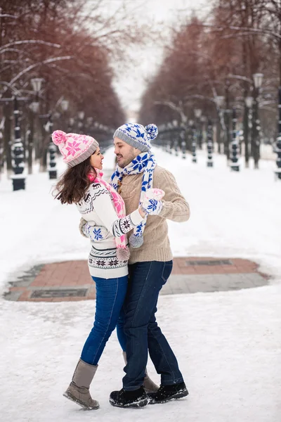 Young couple in love dancing in winter Park