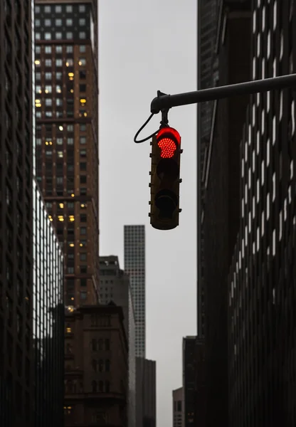 Red traffic light at the crossroads in NYC