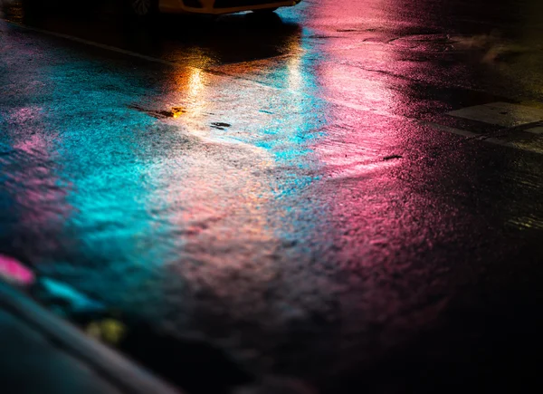 NYC streets after rain with reflections on wet asphalt