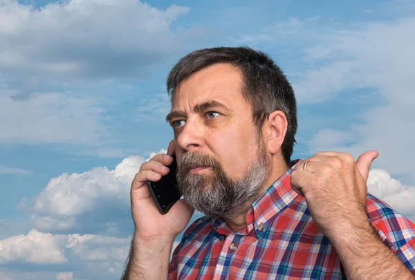Middle-aged man speaks on a mobile phone