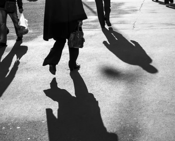 Shadows of people walking in a street
