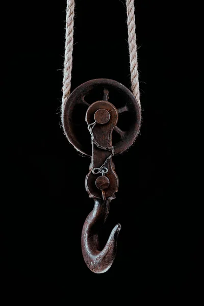 Big metal hook hanging on rope