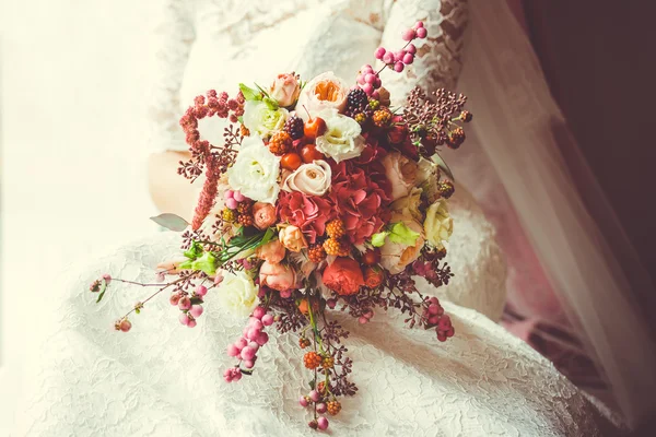 Bridal bouquet with red and burgundy flowers.