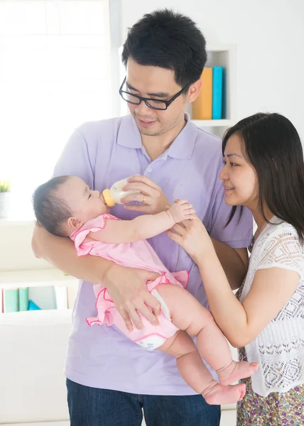 Asian parents nursing baby