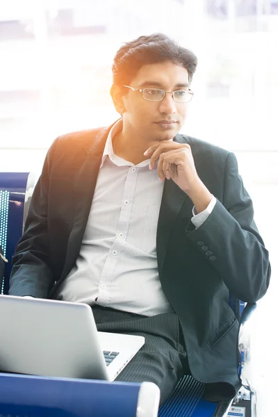 Business man with laptop at airport