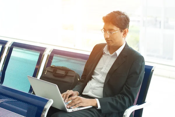 Business man with laptop at airport