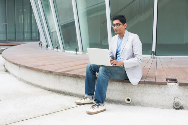 Indian man using laptop