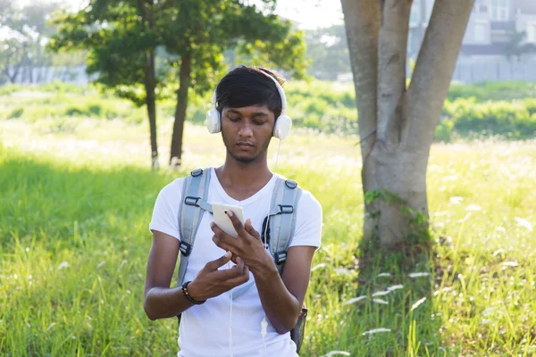 Indian student listening to music