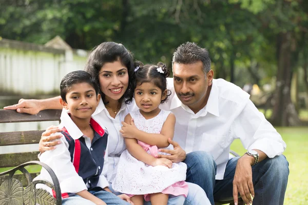 Indian family sitting on bench