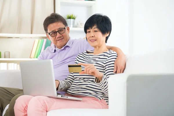 Asian senior couple online shopping