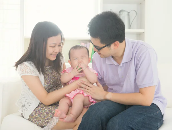Asian parents playing with baby girl