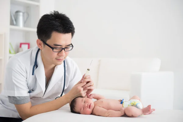Asian doctor and newborn baby