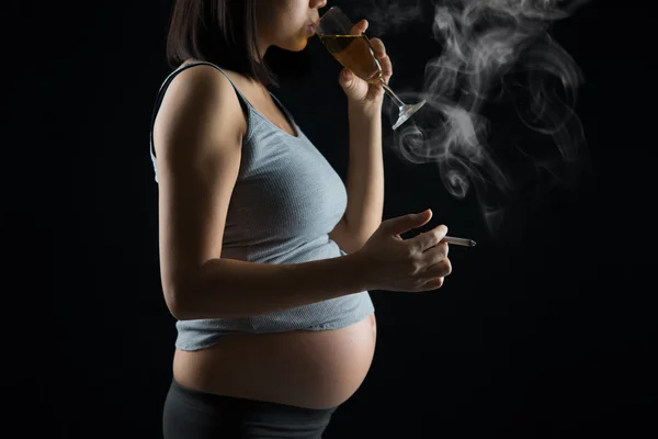 Pregnant mother smoking and drinking