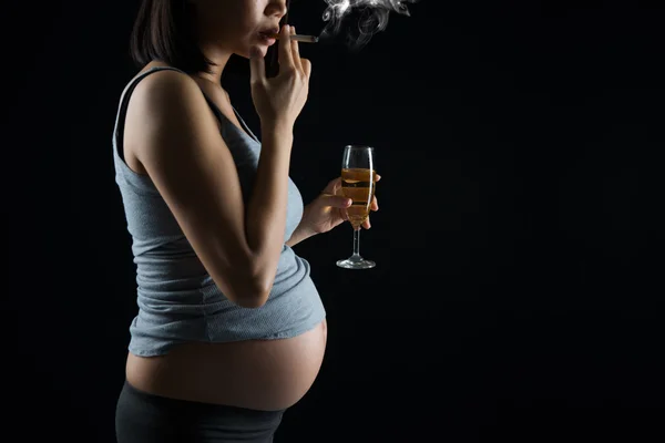 Pregnant mother smoking and drinking