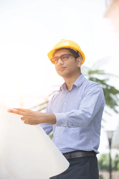 Indian engineer on construction background