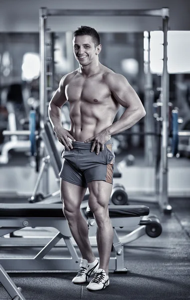 Young man fitness model posing