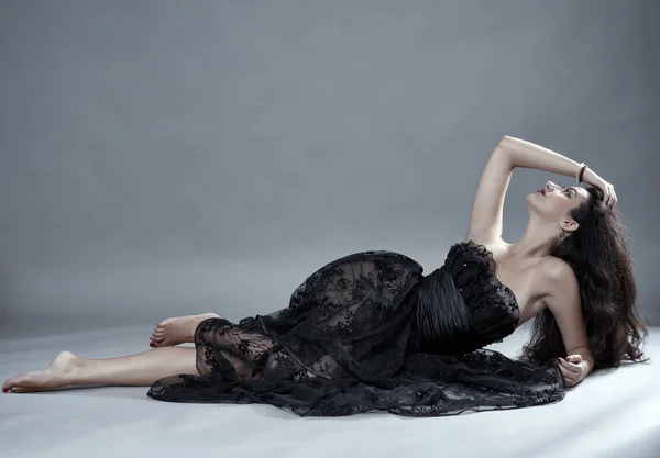 model in black lace dress posing