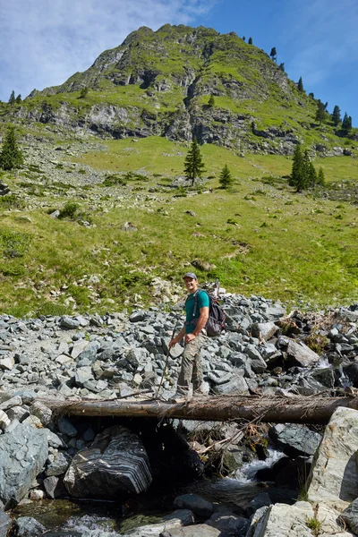 Hiker man crossing a river