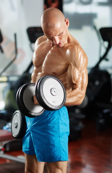Man doing biceps curl in gym