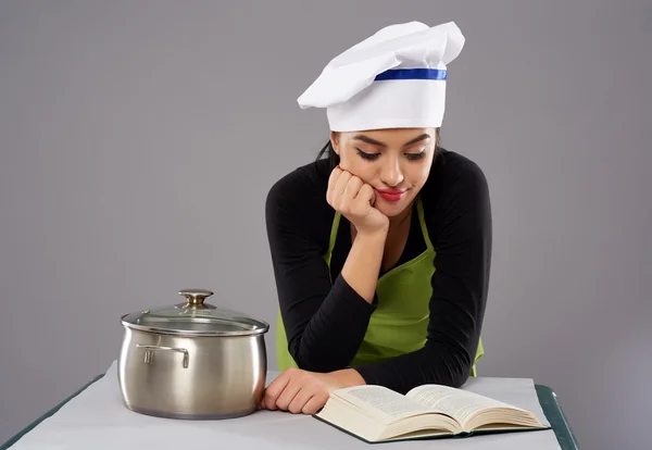 Woman chef reading recipe