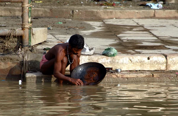 People wade in water during a religious ceremony