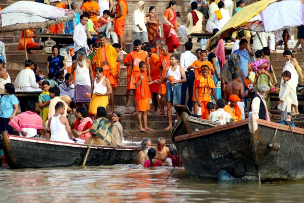 People wade in water during a religious ceremony