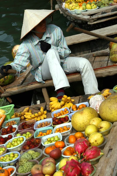 Food vendor works on boats