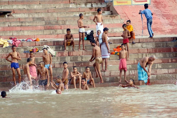 People wade in water during a religious ceremony