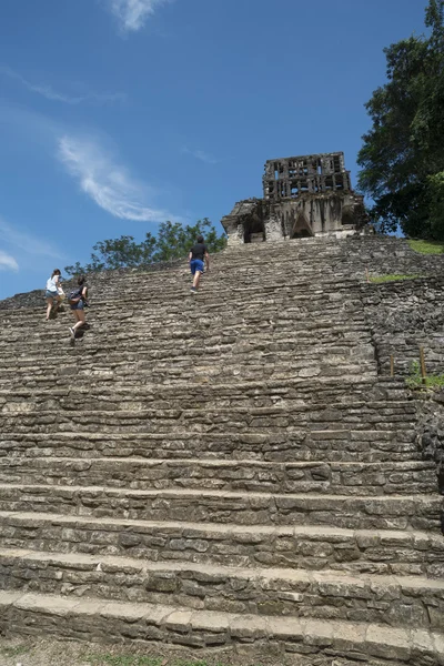 Tourists climb stairs at Palenque site in Mexico