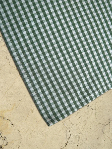 Tablecloth on a stone worktop - folk pattern, green