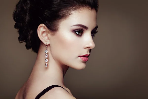 Fashion portrait of young beautiful woman with jewelry