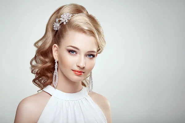 Fashion portrait of young beautiful woman with jewelry