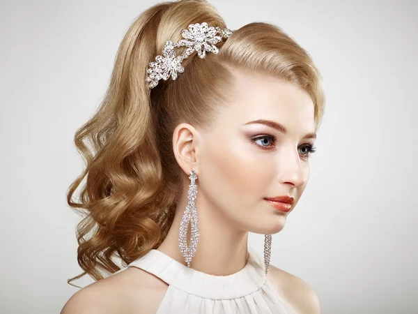 Fashion portrait of young beautiful woman with jewelry