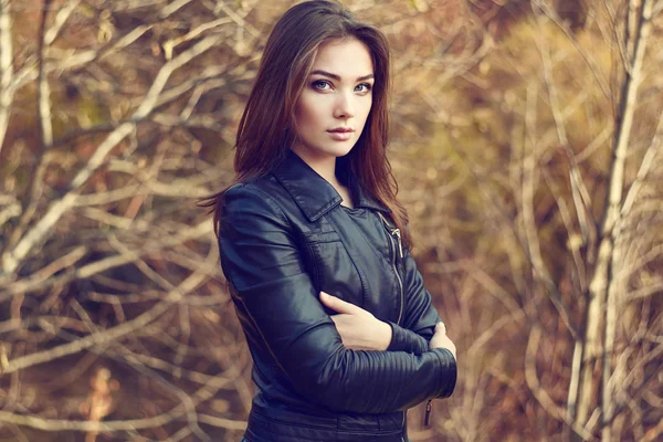 Portrait of young beautiful woman in leather jacket