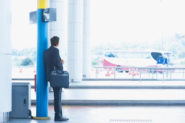 Indian businessman waiting bus