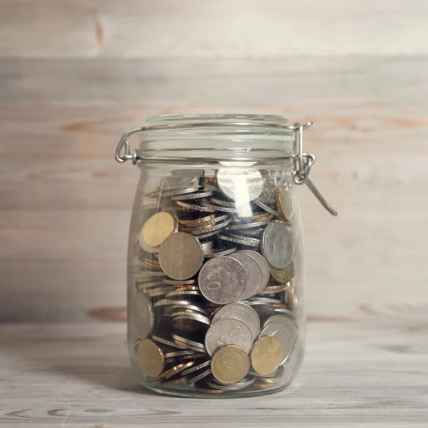 Coins in glass money jar