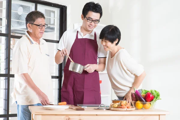 Asian adult son preparing meal