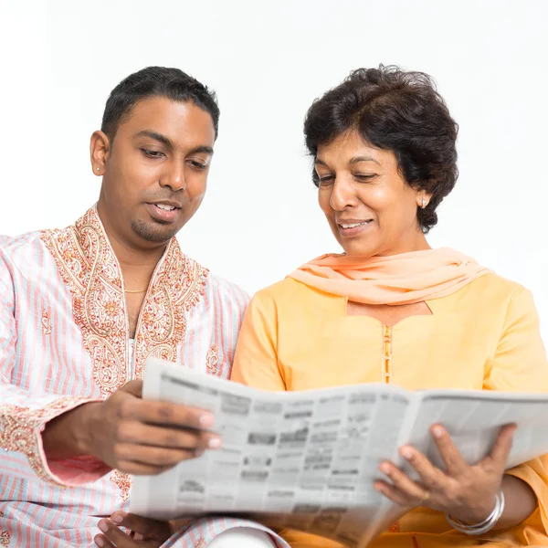Indian family reading newspaper