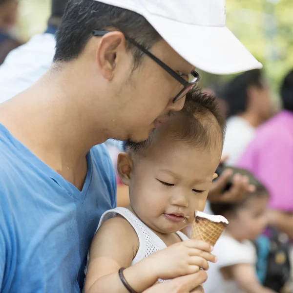 Father and son eating ice creams