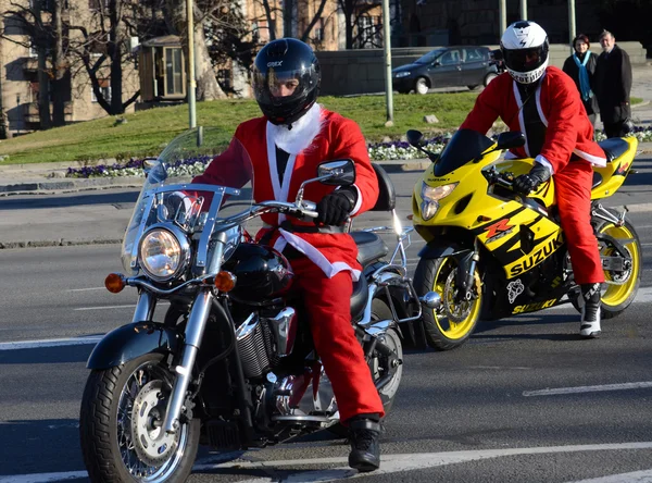 Undefined Santa delivering humanitarian aid in form of gifts to   disabled children during annual Santa Claus Motorcycle Parade on 27 December 2014 in Belgrade, Serbia