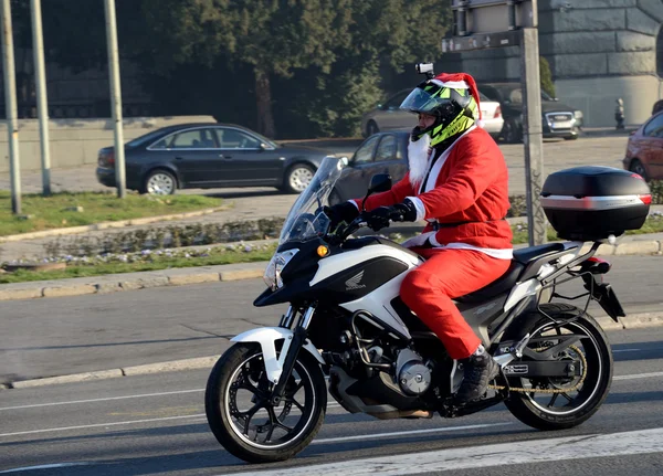 Undefined Santa delivering humanitarian aid in form of gifts to disabled children during annual Santa Claus Motorcycle Parade on 26 December 2015 in Belgrade, Serbia