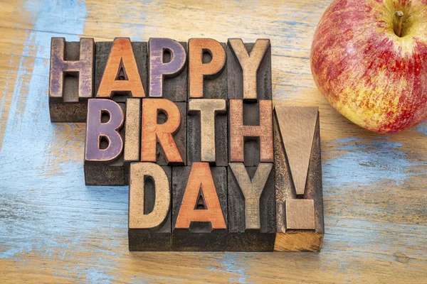 Happy Birthday in wood type with apple