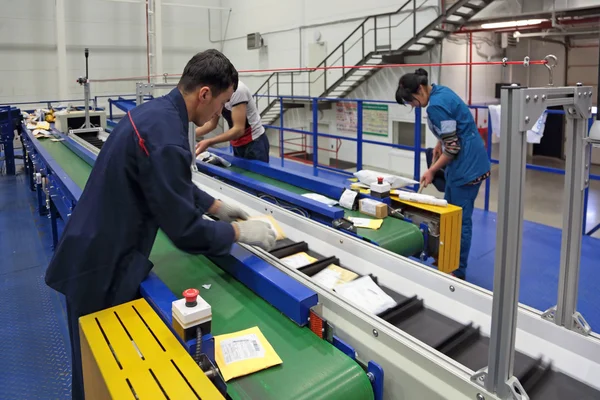 People working on conveyor belt in Logistics center