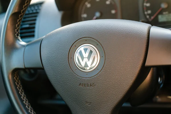 Logo of German car manufacturer Volkswagen on steering wheel