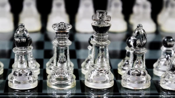 Glass Chess Pieces Set Up In Starting Locations On Board