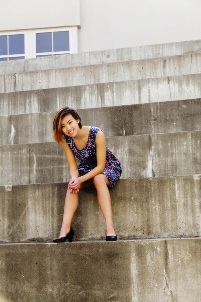 Smiling Attractive Asian American Woman Sitting On Steps